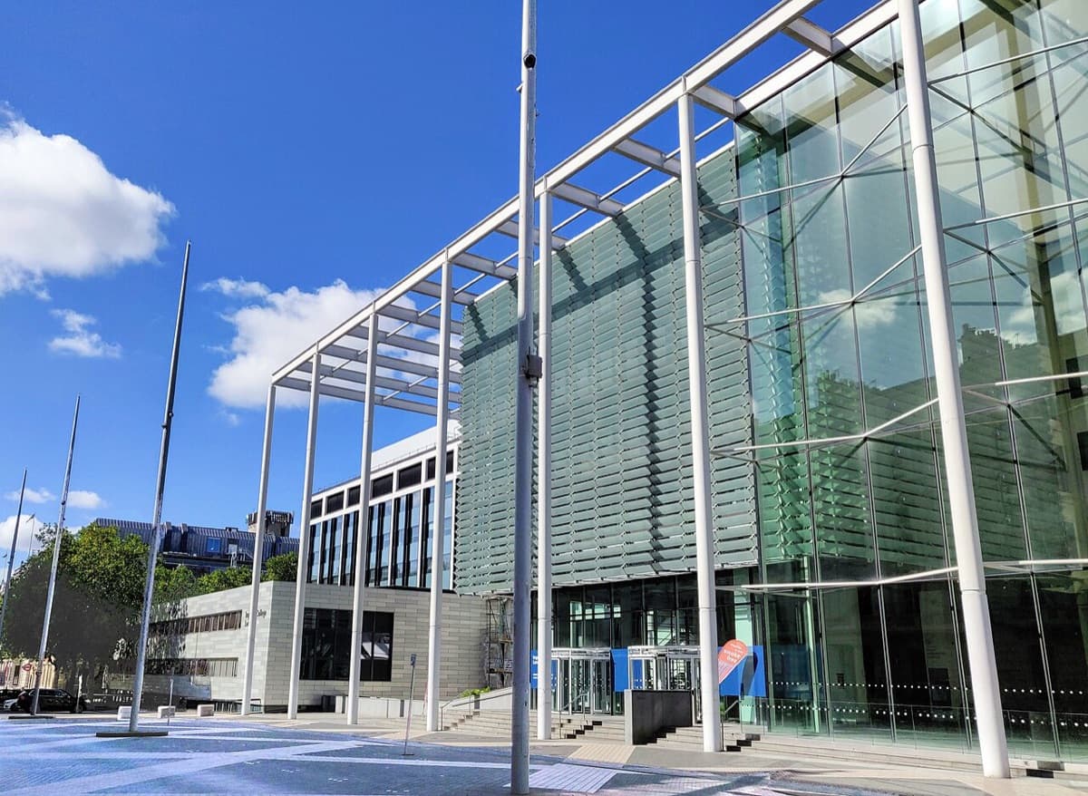 Modern glass and white-frame building entrance to Imperial College London on Exhibition Road, showing contemporary institutional architecture.