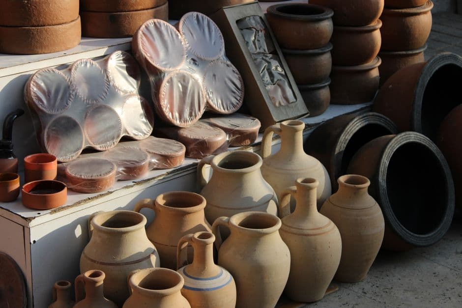 Assorted clay pottery pieces displayed at a local outdoor market.