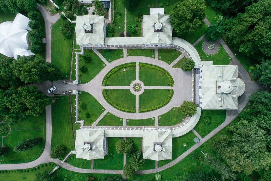 Beautiful aerial view of a historical estate's perfectly manicured gardens and pathways.