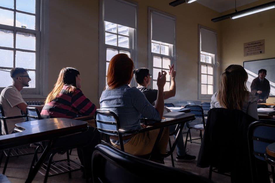 Students attentively listening and participating in a classroom discussion.