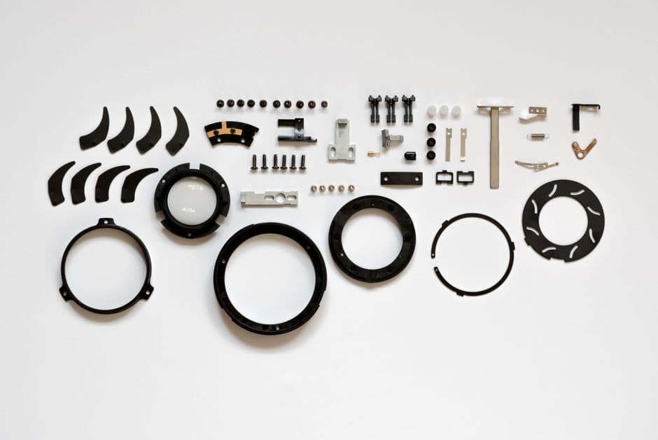 Organized layout of mechanical parts on a white surface, ideal for tech and engineering themes.