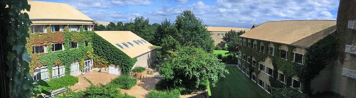 Panorama of Aarhus University Department of Mathematical Sciences campus with multiple buildings.