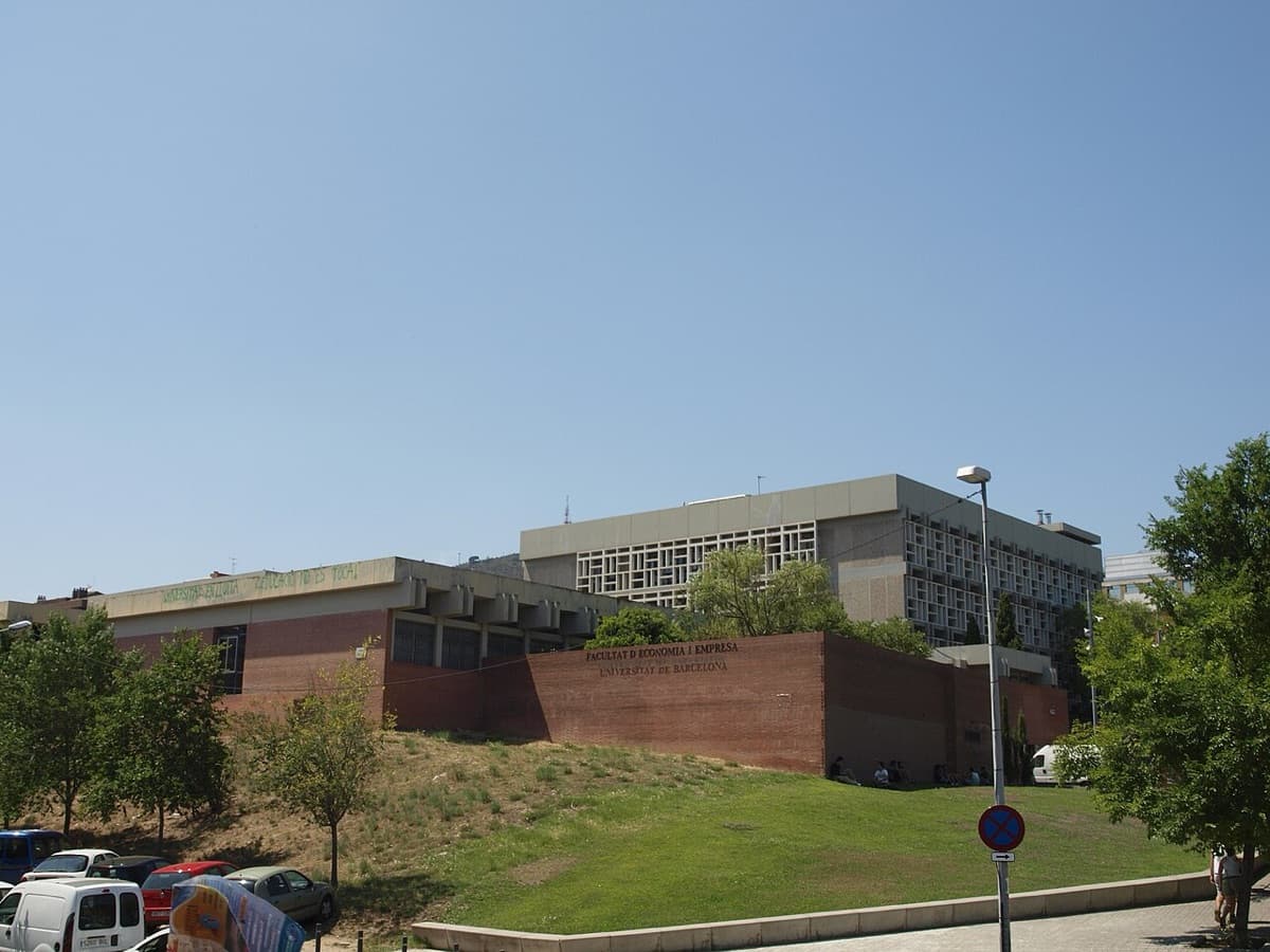 University of Barcelona economics building exterior with red brick and modern additions.