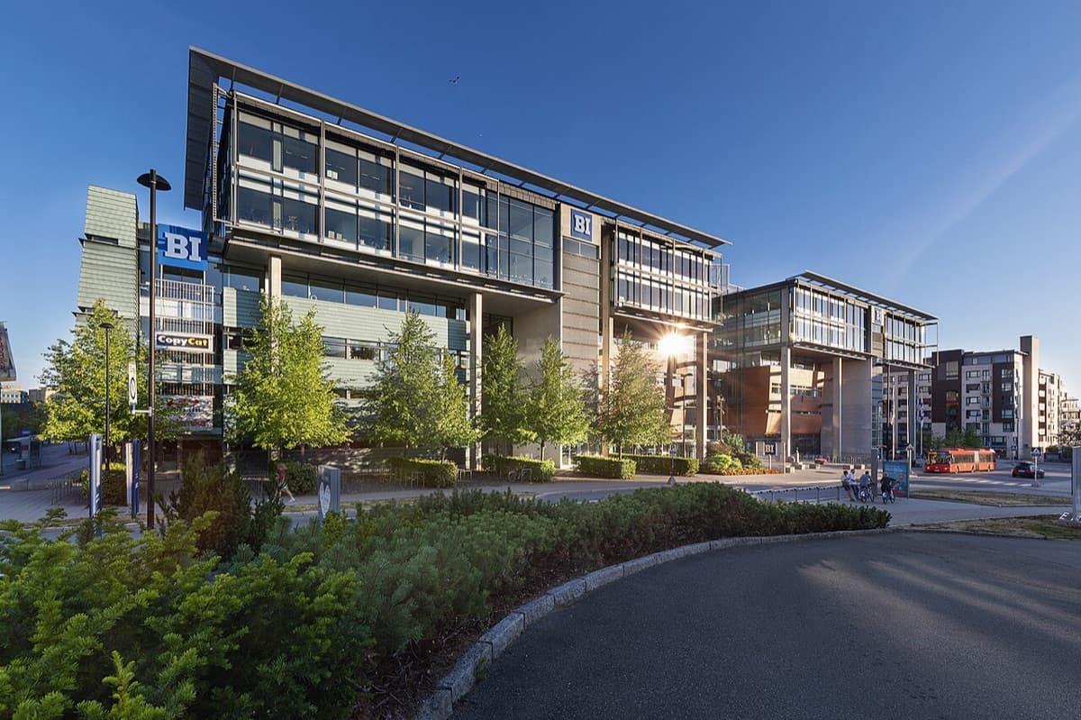 BI Norwegian Business School modern campus building at golden hour with clear institutional signage and landscaping.