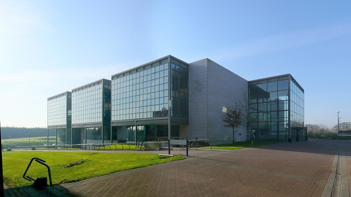 DCU Glasnevin Library, a modern glass and concrete building with landscaping at Dublin City University.