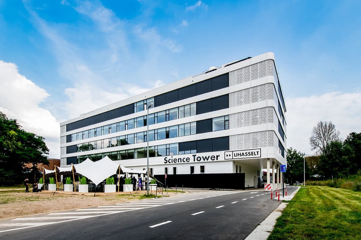 Science Tower of Hasselt University showing modern white multi-story building with geometric facade and clean contemporary design.