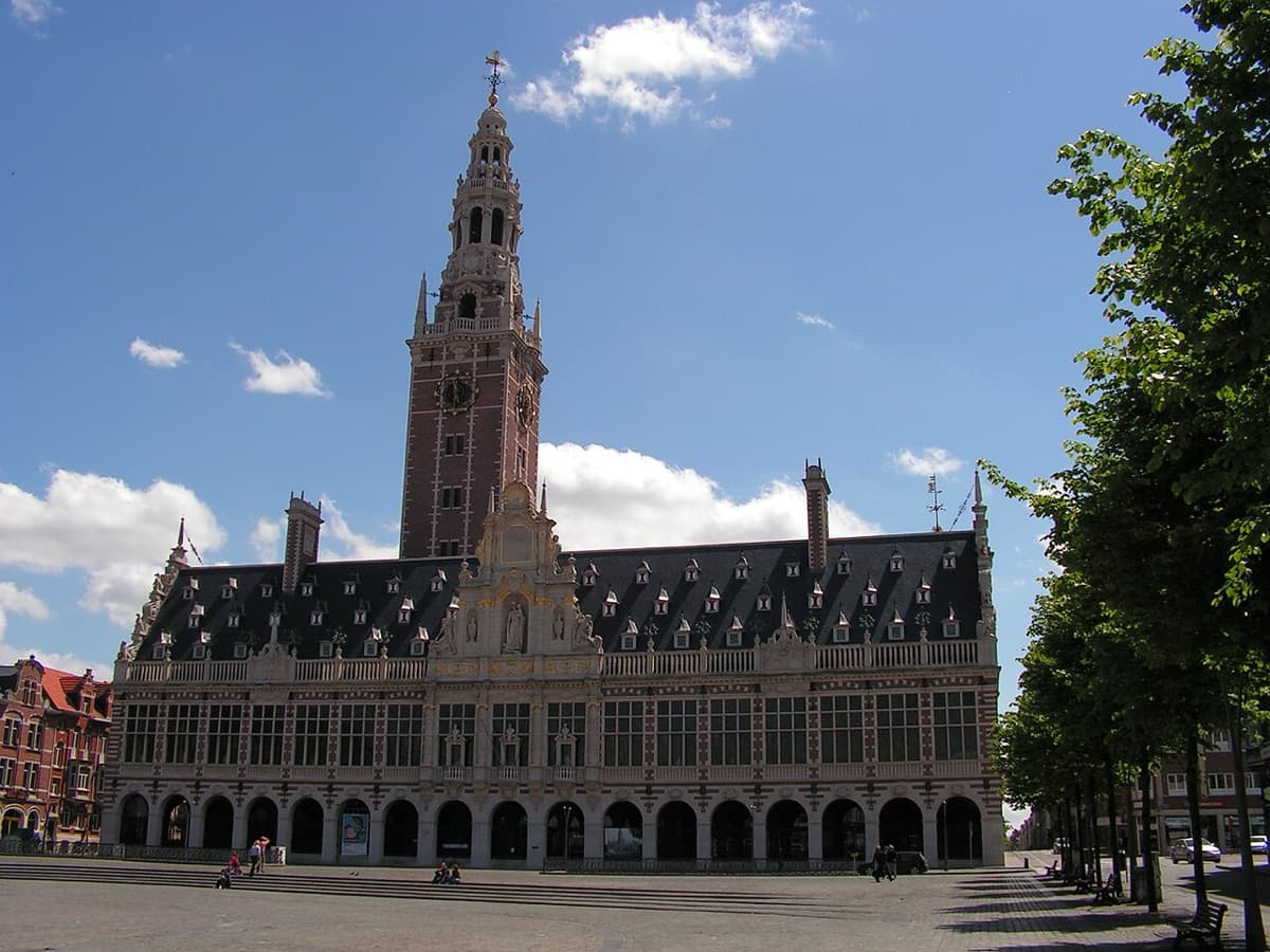 Historic library building of KU Leuven displaying Flemish architecture with ornate facade, turrets, and distinctive red roof detail.
