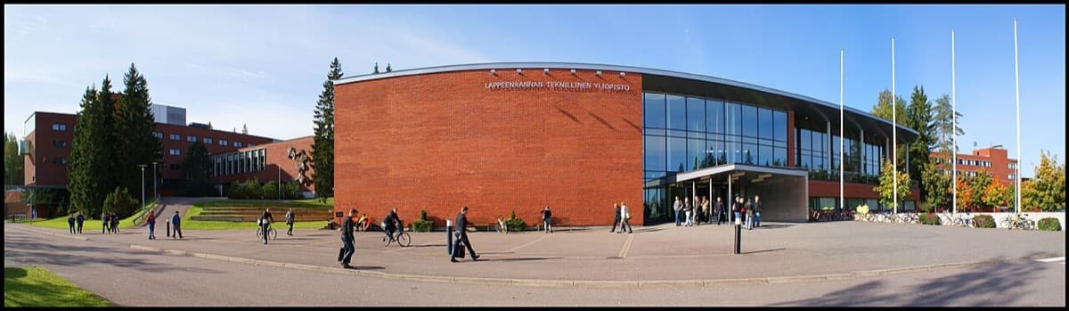 LUT University modern campus building featuring distinctive curved glass wing and red brick architecture.