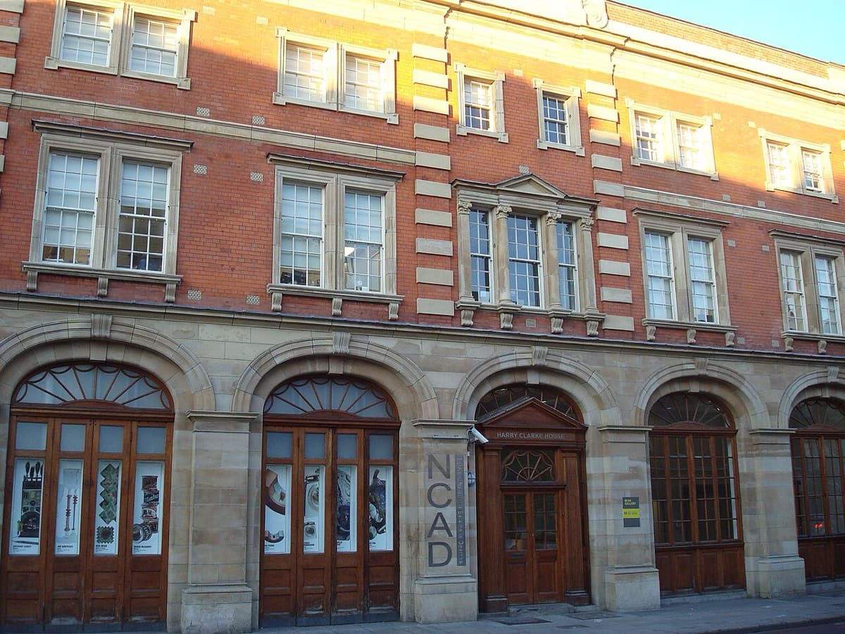National College of Art and Design building entrance facade showing historic red brick architecture with arched doorways on Thomas Street Dublin.