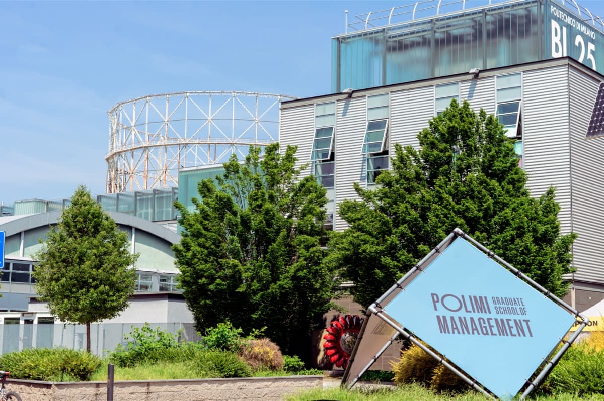 The Navigli Campus of Politecnico di Milano School of Management showing modern building structure with landscape and signage.