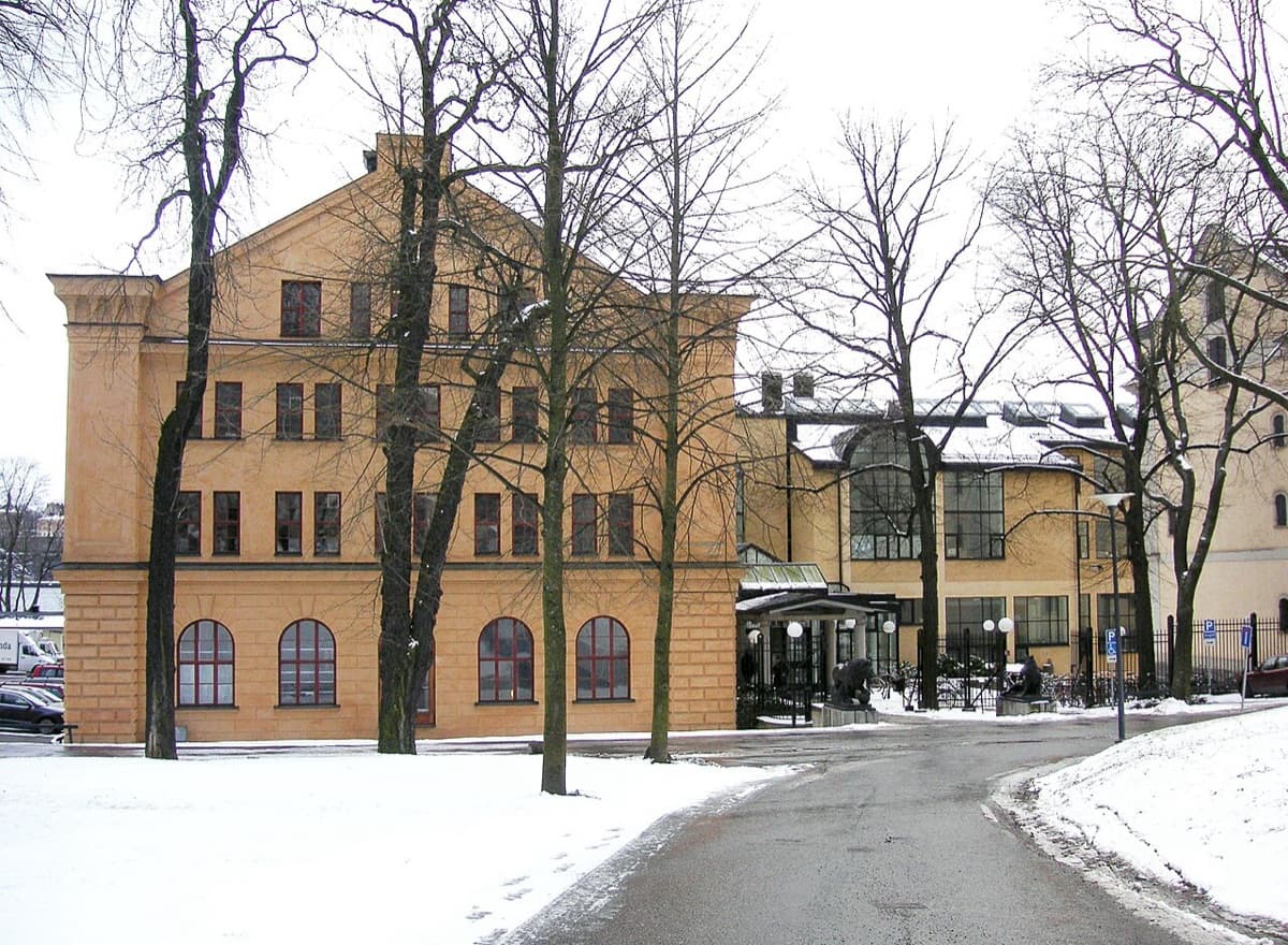 Royal Institute of Art (Kungliga konsthögskolan) on Skeppsholmen in Stockholm, showing characteristic institutional building with snow and bare trees in winter setting.