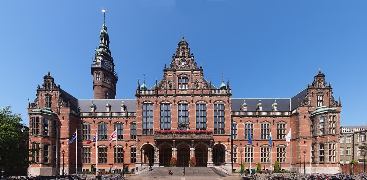 Red brick Academiegebouw main building of University of Groningen with ornate roof and distinctive architectural features.