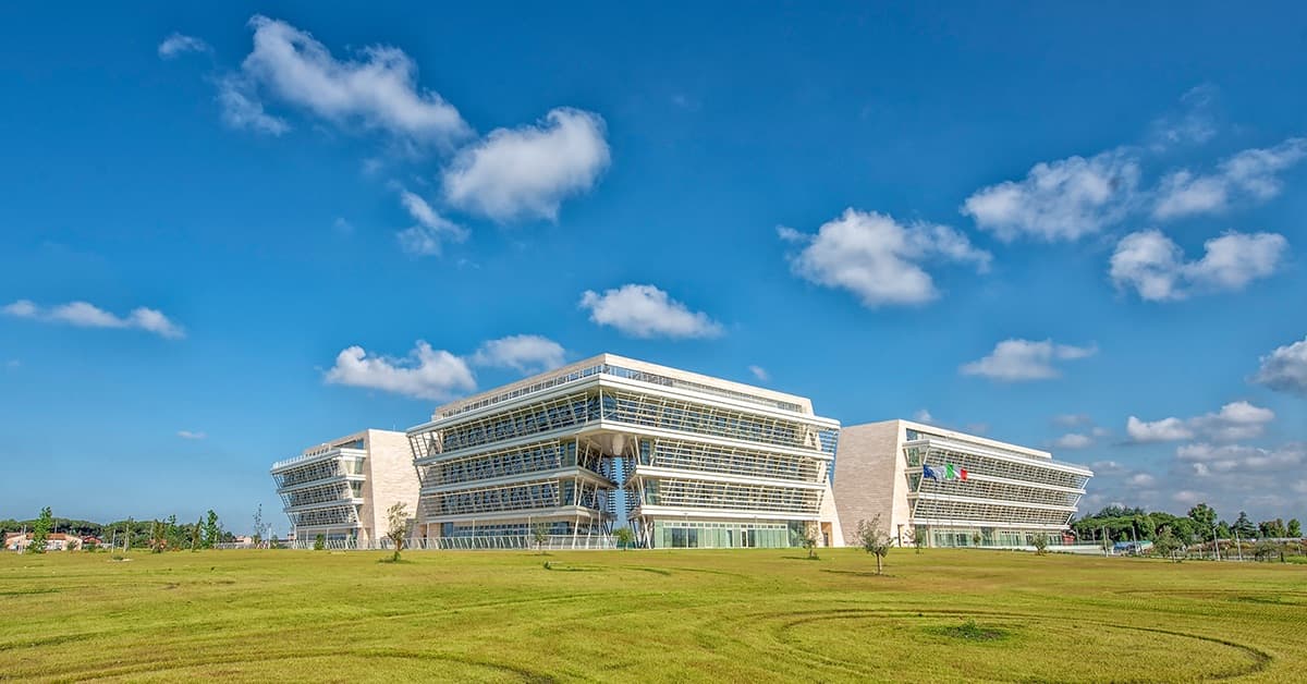 A distinctive curved modern building of Università di Roma Tor Vergata with contemporary architectural design set in landscaped campus grounds.