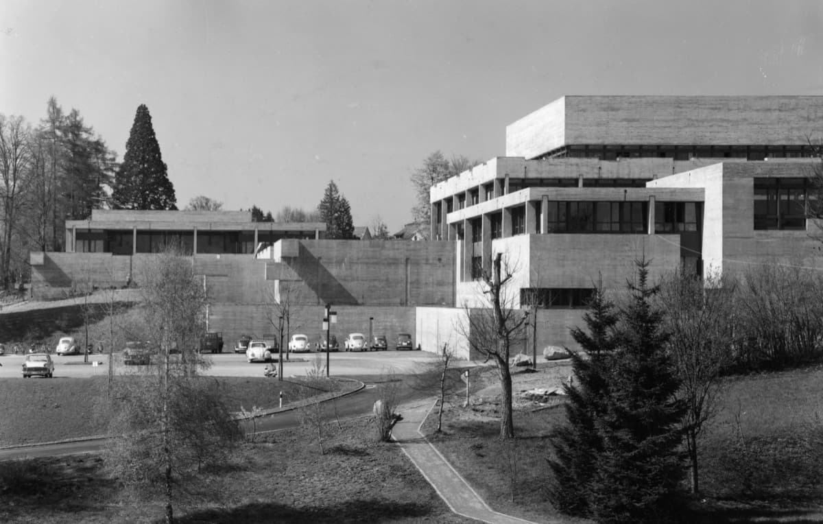 HSG campus from 1963 showing modernist buildings with landscape and trees, St. Gallen.