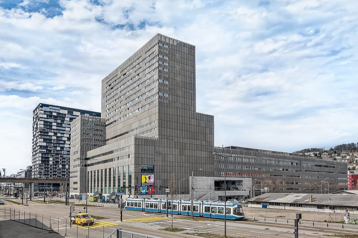 Zürcher Hochschule der Künste main campus building at Toni-Areal with tram and urban context.